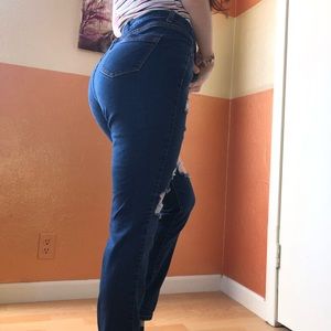 Dark blue jeans with multiple holes